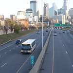 metro transit bus driving on the freeway away from downtown minneapolis
