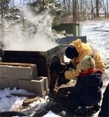 turning sap into maple syrup outside in the winter