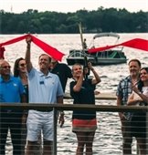 the mayor cutting a red ribbon