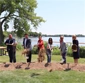 elected officials tossing sand during a ground breaking ceremony