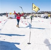 person cheering while golfing in the winter