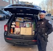 wayzata pd delivering gifts to toys for tots in a squad car