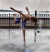 boy playing in the splash pad in wayzata