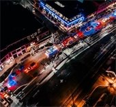 parade of first responder vehicles lit up at night