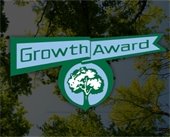 growth award with tree photo in the background