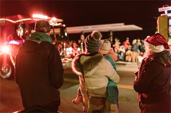 a family watching the parade of lights in wayzata