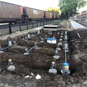 Underground plumbing and wiring for the interactive water feature, just south of Walker Avenue