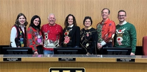 city council and staff in holiday sweaters