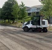 street resurfacing vehicle on broadway ave