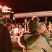 woman and child watching parade at night