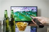 Football game on TV with beer and chips