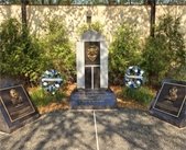 police memorial stone with blue line and flowers with two memorial stones for Wayzata's fallen officers. 